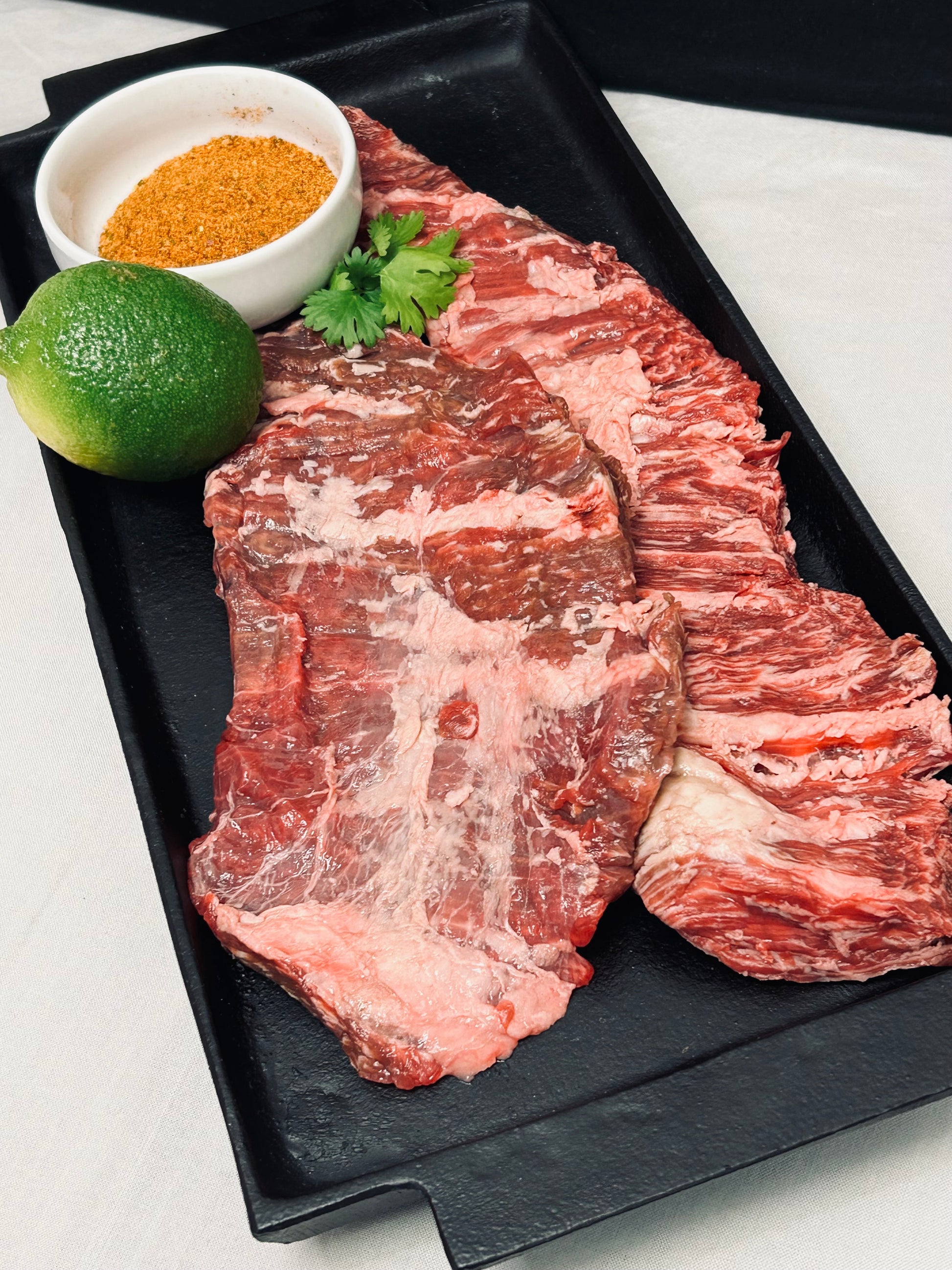 Close-up of 50lb Texas pasture-raised grain-finished beef box label highlighting farm origin and weight details.