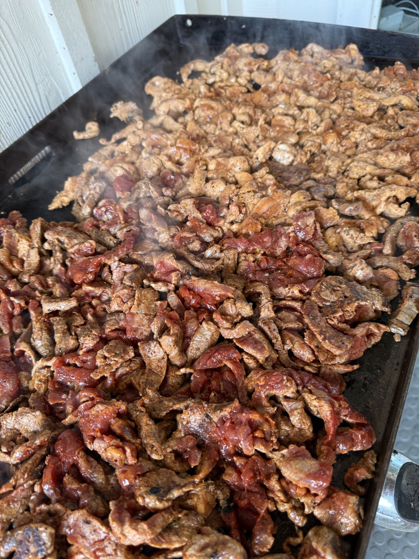 Close-up of beef cuts showcasing marbling and grain-finished texture on a butcher’s tray